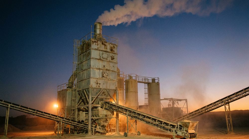 Industrial flash calciner unit processing kaolinitic clay at an Indian cement plant, with rising thermal plume against a dusk sky.